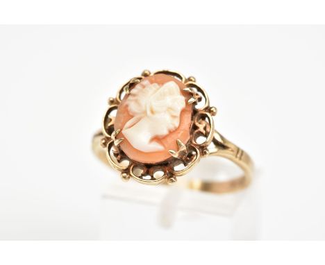 A 9CT GOLD CAMEO RING, of oval design depicting a lady in profile within a four claw setting and scalloped surround, to the b