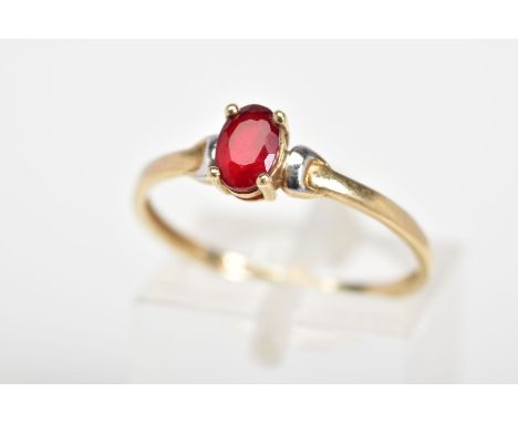 A SINGLE STONE RING, designed with an oval cut red stone assessed as paste, to the plain polished band, stamped 9ct, ring siz