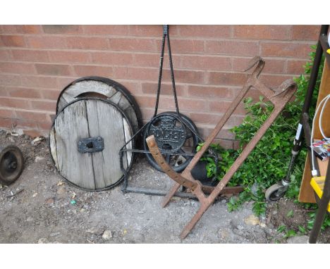 A VINTAGE CAST IRON 'IRONCRETE' GARDEN ROLLER FRAME, length 84cm, two steel ringed wooden wheels 46cm in diameter, a drain ho