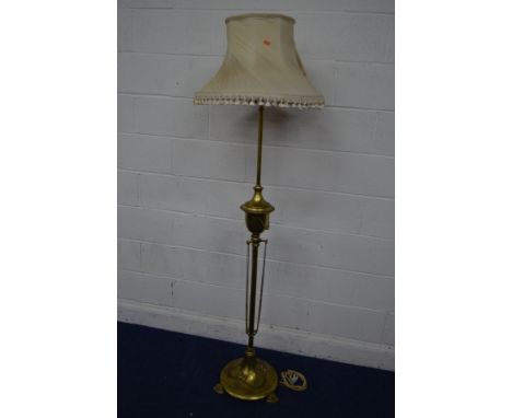AN EARLY TO MID 20TH CENTURY BRASS TELESCOPIC STANDARD LAMP, on a circular base with claw feet, with a fabric shade, height t