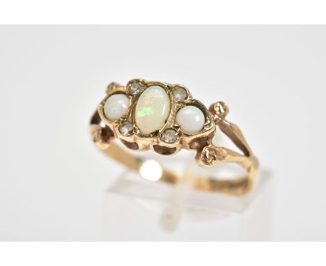 A 9CT GOLD THREE STONE RING, designed with a central oval opal flanked by two further circular cut opals, with colourless sto