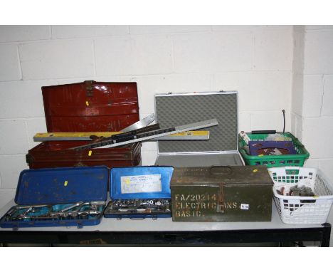 A VINTAGE TIN BOX, AN AMMO CASE, two baskets all containing tools, saws, an aluminium instrument case and two incomplete sock