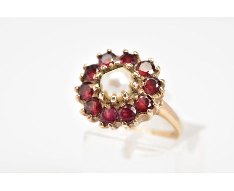 A 9CT GOLD CLUSTER RING, designed with a single cultured pearl centre and circular cut garnet surround, to the plain polished