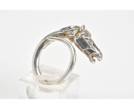 A SILVER RING, designed as a detailed horse head and wrap around tail, with a London hallmark, ring size I, approximate weigh