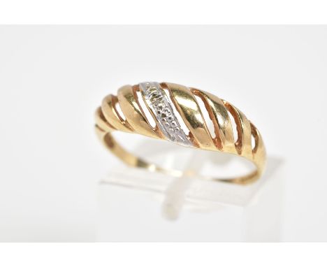A 9CT GOLD RING, designed as a row of diagonal openwork panels with the centre panel set with a small diamond, to the plain p