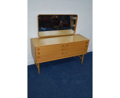 A 1960'S MEREDEW LIGHT OAK DRESSING CHEST, with a rectangular mirror with rounded corners on twin cylindrical legs, width 132