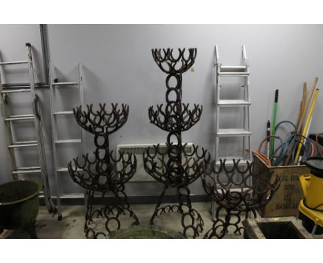 An architectural garden planter stand formed from horseshoes, width 67 cm, height 175 cm.