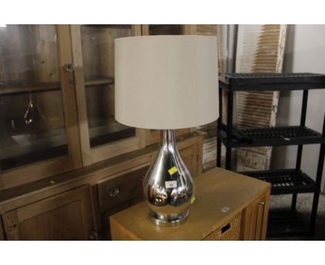 Modern bottle shaped table lamp with cream shade