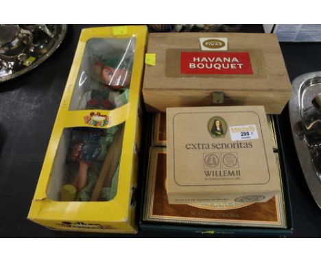 Four cigar boxes containing match books and a Pelham puppet