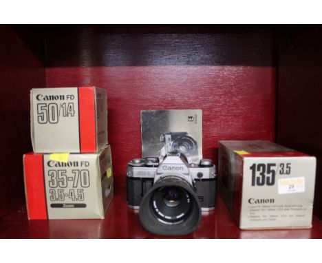 Canon AE1 camera and three lenses 