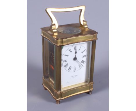 A French early 20th century brass carriage clock, retailed by Pridham & Sons, Torquay, with white painted dial and black pain