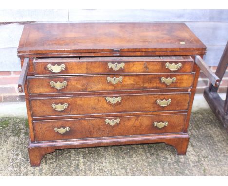 An early Georgian walnut and banded fold-over top chest of four long graduated drawers, on bracket feet, 38" wide