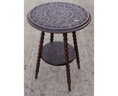 A 19th century chip carved walnut circular two-tier occasional table, on bobbin turned supports, 20" dia