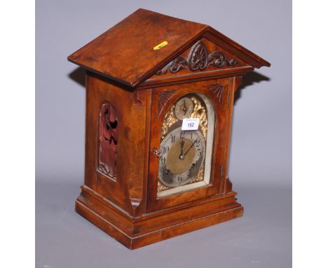An early 20th century walnut cased bracket clock with brass and silvered dial, 15" high