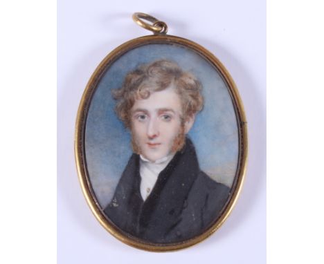 An early 19th century portrait miniature of an unknown gentleman with gold stick pin, 2.25" x 2.8", in oval brass frame