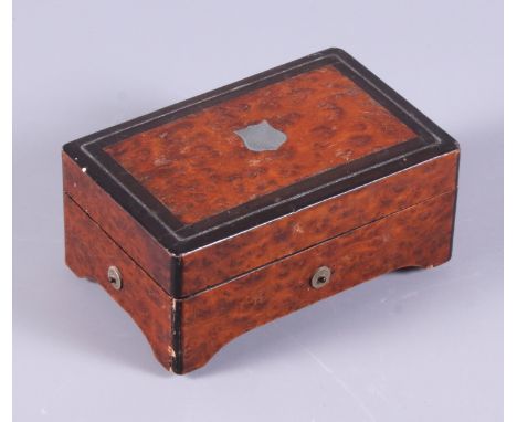 A mid 19th century Swiss walnut cased six air music box, the hinged lid with metal stringing decoration, on bracket feet with