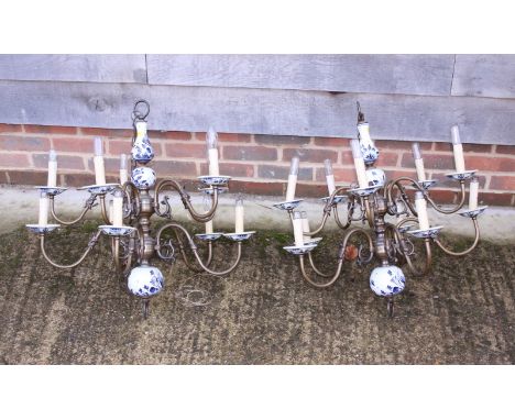 A pair of Dutch brass and ceramic ten-light ceiling pendants of 17th century design