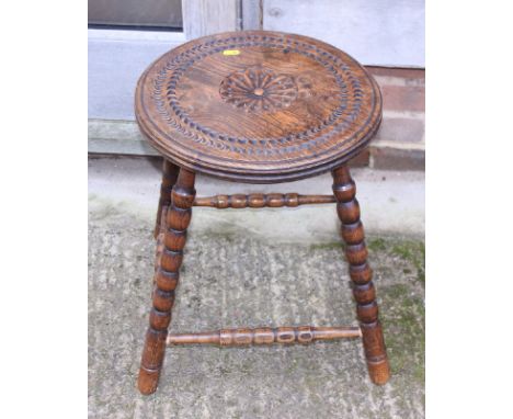 A 19th century chip carved elm circular top occasional table, on bobbin turned and stretchered supports, 15" dia