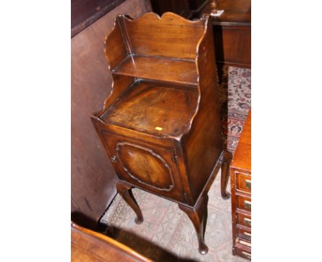 A walnut and banded bedside cabinet, fitted shelf over tray top, on cabriole supports, 15" wide