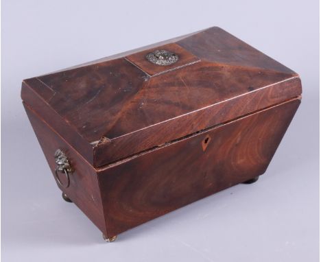 A Regency mahogany three-division sarcophagus tea caddy with twin lion mask handles, on brass feet, 6 1/2" wide, together wit