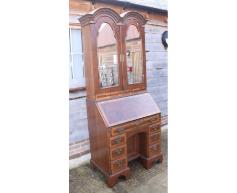 A burr walnut and banded double dome top bureau bookcase of Queen Anne design, the upper section with candle slides and mirro