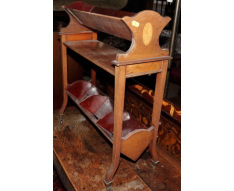 An Edwardian mahogany and inlaid book trough, on castored supports, 21" wide