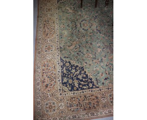 A Persian design bordered carpet, green field decorated foliage and animals, central lobed medallion, 12ft x 9ft