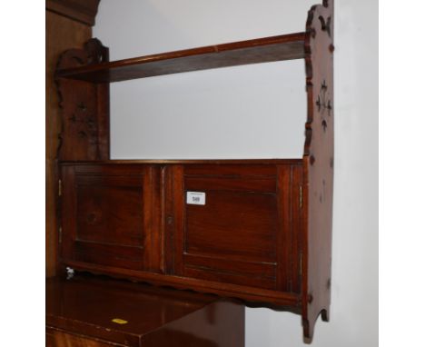 A late Victorian mahogany hanging two door wall shelf