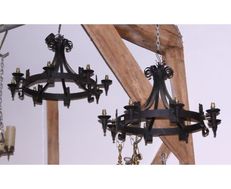 *A pair of black japanned wrought iron circular eight-light chandeliers of 16th century design*This Lot is also subject to VA