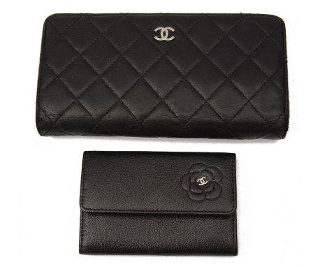 A black quilted Chanel purse and a small Chanel card casethe former black classic quilted purse with logo to front opening to