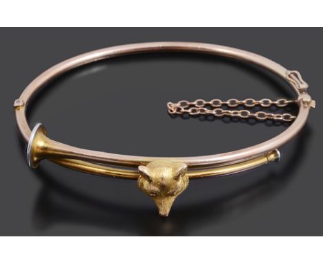An Edwardian fox and hunting horn hinged banglethe bangle formed as a curved hunting horn and set with a foxes head, engraved