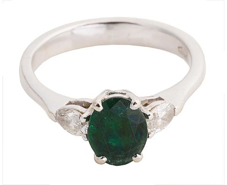 A Continental emerald and diamond three stone ringthe central oval emerald set between two small navette cut diamonds, 18ct w