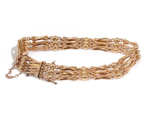 An attractive Edwardian 15ct gold gate bracelethaving three fancy crossover bars spaced with triple sphere links, invisible p