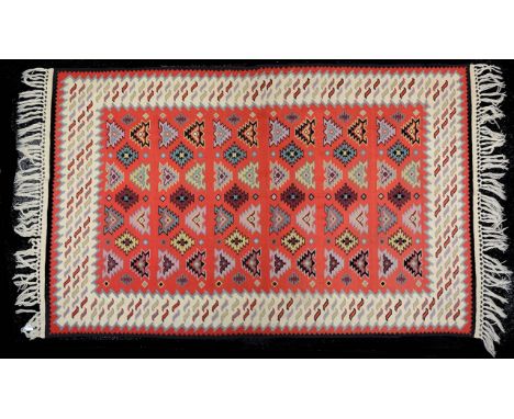 A Turkish red ground Kelim ruglength 235 cm including fringe, width 131 cm. Condition: Good condition. Some occasional light 