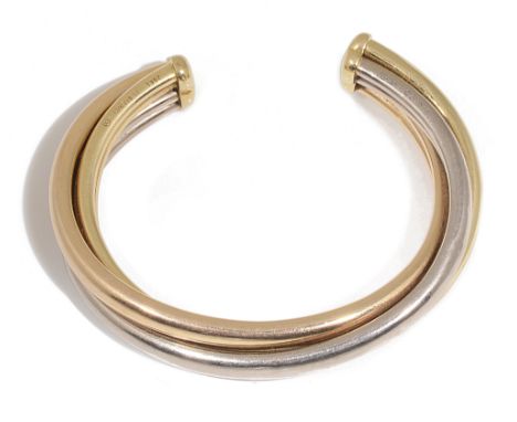 A Cartier three colour gold Trinity open bangleformed as three 18ct yellow, white and rose gold interlacing bands, signed Car