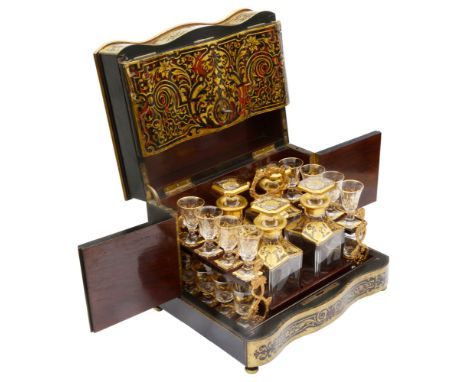 A 19th century French ebonised and red boulle work tabletop decanter box serpentine fronted, the hinged lid and sides contain