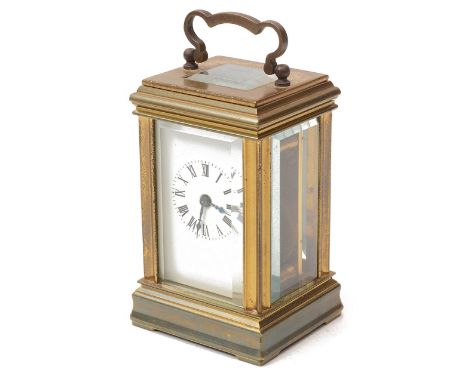 An early 20th century brass miniature carriage clockthe white enamel dial with black Roman numerals, 8 day movement, the back