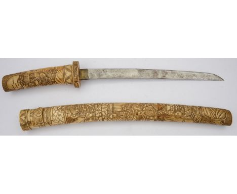 A Japanese Meiji period bone tanto c.1900the 12" curved steel blade , with bone handle and scabbard all over relief carved wi