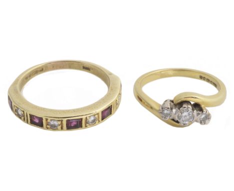 A three stone diamond ring and a diamond and ruby ringthe three stone diamond twist ring marked for 18ct gold, together with 