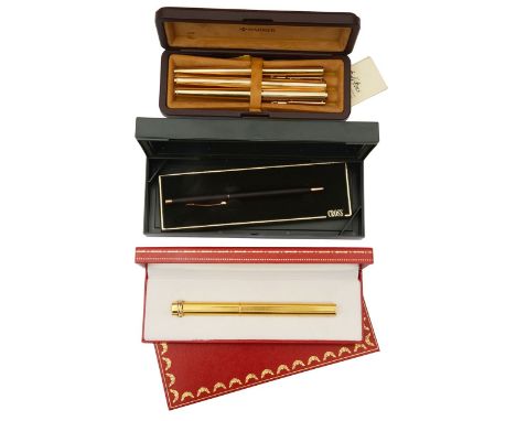 A Le Must de Cartier gold plated ball point pen with engine turned decoration, in original gilt tooled red leather fitted box