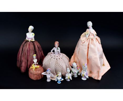 A Large Collection Of Ceramic Boudoir Half Dolls Ten in total, four as complete dolls/pin cushions, six half dolls, each in p
