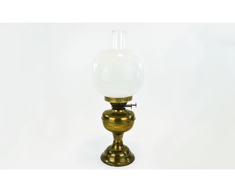 Brass Oil Lamp Of plain form with inner glass tube and removable outer glass globe shade