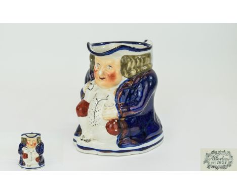 Staffordshire 'Foaming Ale' Toby Jug, c1840, typical stout jolly figure in cobalt blue coat and white, gold spotted waistcoat