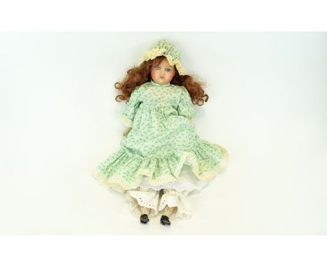 Bisque Headed Cloth Bodied Doll, probably German, late 19th century, the bisque head on fixed shoulders, closed to the pate; 