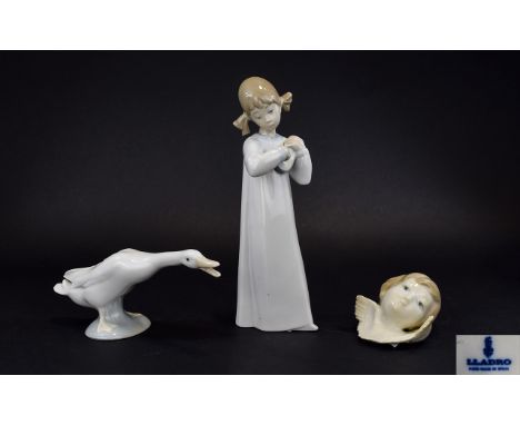 A Collection Of Lladro Figures Three in total to include Young girl playing guitar, small cherub and glazed goose