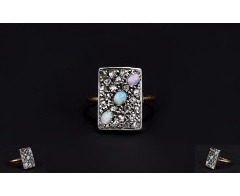 Antique Period Opal And Diamond Ring set in a gold and platinum. Not marked. The three opals surrounded by old cut diamonds. 