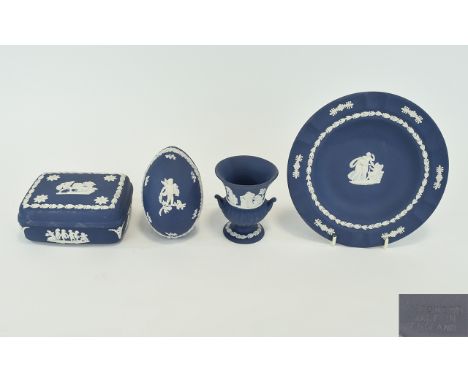 A Collection Of Wedgwood Portland Blue Jasperware Four items in total, each boxed to include trinket box, small plate, egg sh