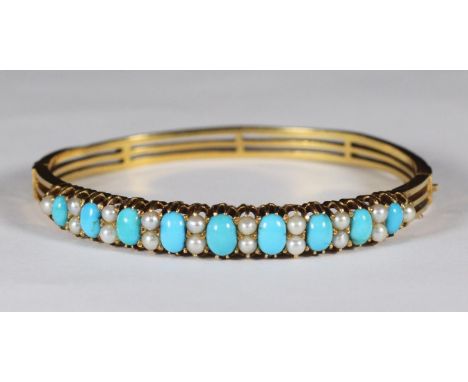 An 18ct gold bangle set with oval turquoise and pearls.  Total weight of bangle 21.2g 