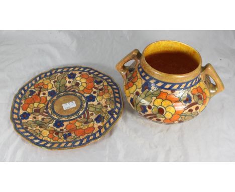 A two-handled pottery vessel by Charlotte Rhead for Crown Ducal, with multicoloured floral, tubelined deoration, to a mottled
