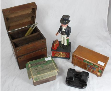 A novelty cast-iron money box modelled as Uncle Sam, raised on pedestal base, 28cm high and a View-Master 'Stereoscope' with 